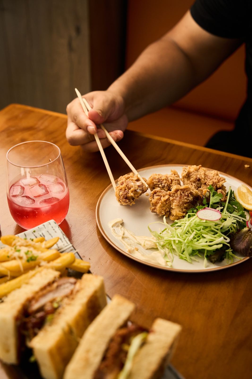 Guests sharing karaage and a Ramen Shack sando at the table